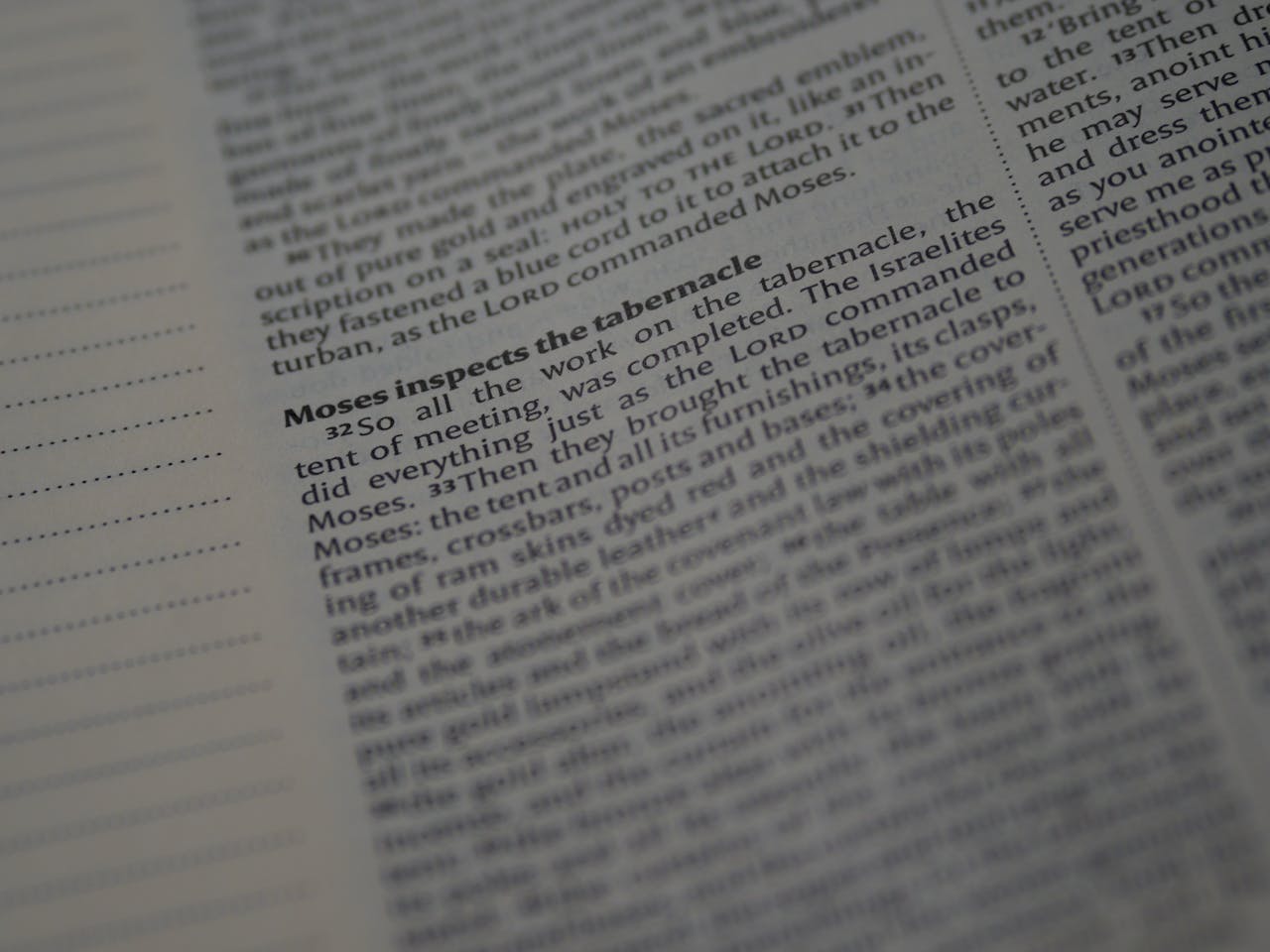 Detailed close-up of a Bible page featuring the story of Moses inspecting the tabernacle.